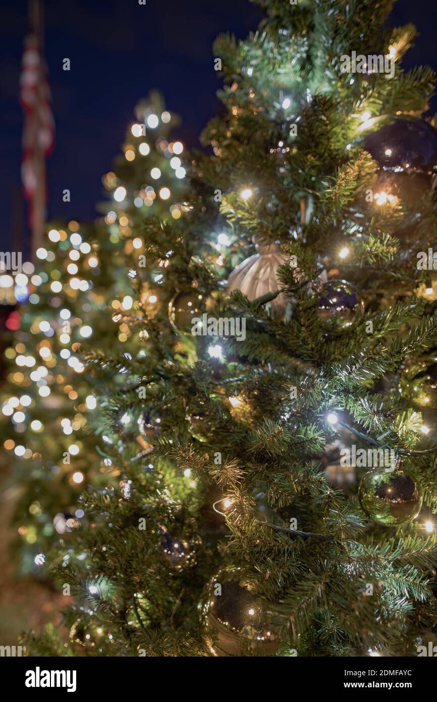 Christmas tree display with flag in background. Stock Photo