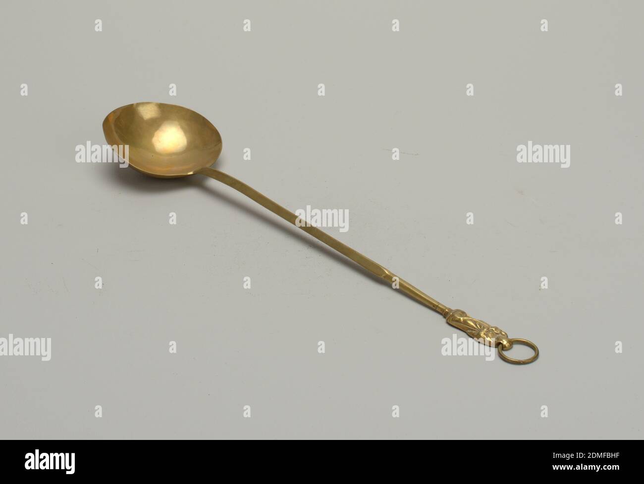 Spoon, Brass, Large circular bowl. Long handle terminating in a robed figure whose head is pierced to receive a loop., France, ca. 1550, metalwork, Decorative Arts, Spoon Stock Photo