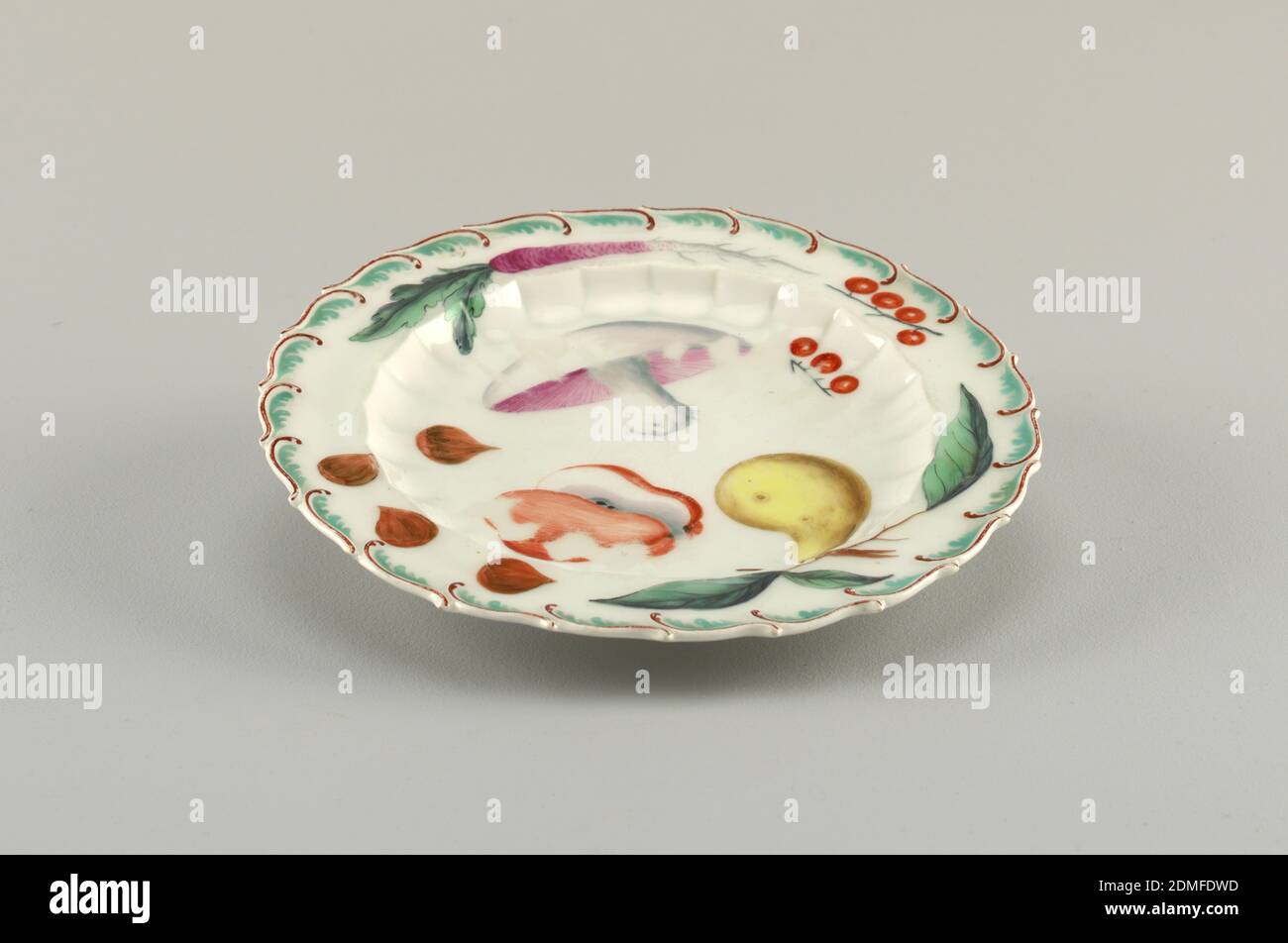 Fruit Plate, Chelsea Porcelain Manufactory, English, established ca. 1743/45, soft paste porcelain, vitreous enamel, Flat marly springing from scalloped inner rim. Raised, feathered edge, painted brown and green. In center, large and small cucumber and an apple. On marly, three rose hips, a purple long radish, currents and small red berries., England, 1753–1758, ceramics, Decorative Arts, plate, plate Stock Photo
