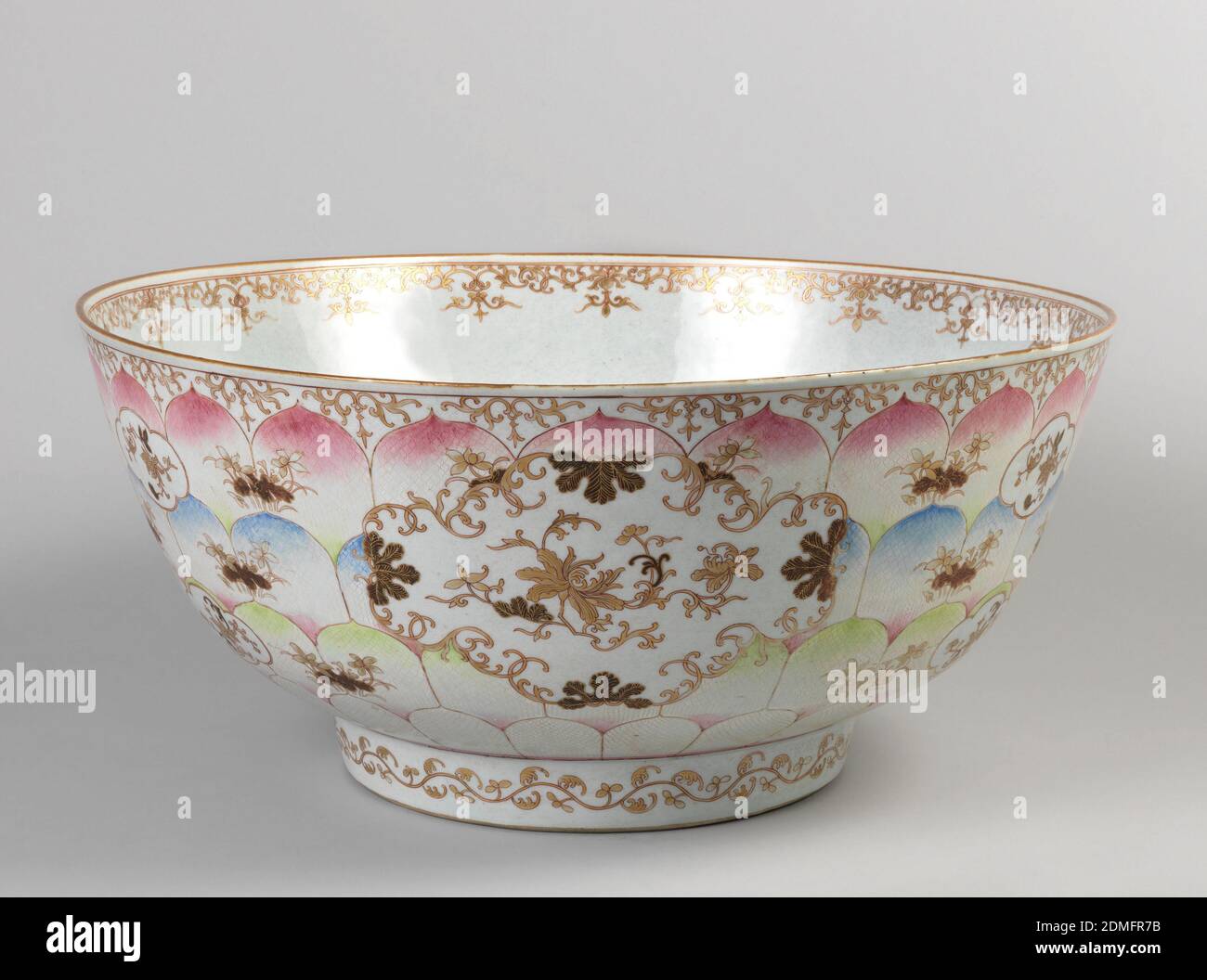 Bowl, Glazed porcelain, Deep round bowl on high foot. Pale blue ground flecked with umber. Centered with lotus plants in aubergine and gold penciled with red; outer walls have four rows of etched and colored lotus petals, and scrolled medallions., China (for export), 18th century, ceramics, Decorative Arts, Bowl Stock Photo