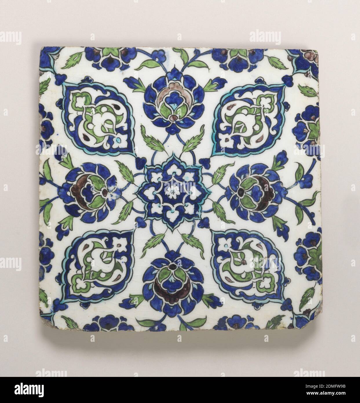 Tile, Tin-glazed earthenware, underglaze decoration, Square in shape, painted with an 8-pointed blossom in the center, from which radiate stylized floral arabesques and blossoms., Ottoman Empire (possibly Syria), late 16th–early 17th century, tiles, Decorative Arts, Tile Stock Photo
