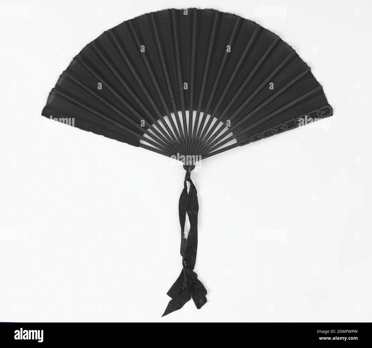 Pleated mourning fan, Duvelleroy, (Paris, France, founded 1827), Silk crepe leaf, painted wood guards and sticks inlaid with black spangles, guards cut à jour, horn washer and metal loop at the rivet, silk ribbon, Pleated mourning fan. Black silk crepe leaf. Black painted wood guards and sticks are inlaid with round black spangles. Guards cut à jour in a strapwork design of interlacing ovals and hexagons. Horn washer and metal loop at the rivet with black silk ribbon., Paris, France, 1885–90, costume & accessories, Pleated mourning fan Stock Photo