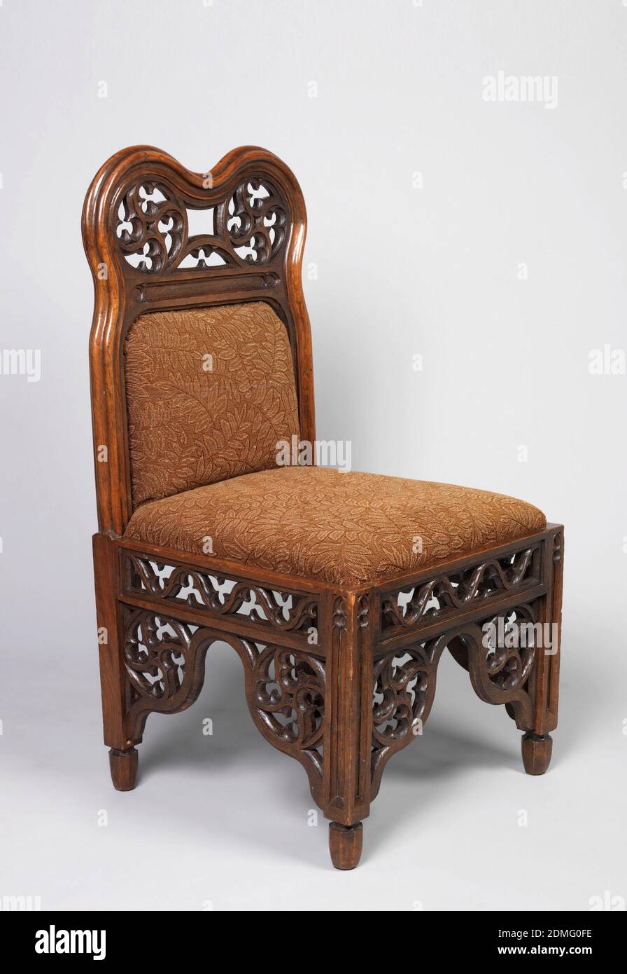 Side chair, Samuel Pratt, L.N. Cottingham, Oak, Side chair with upholstered seat and back in brown leaf pattern. Frame surrounding back: two lobes bordering circles of lattice work decorated with trefoils; same lobes present at legs, above which is a lattice work stretcher on all four sides of chair., England, 1844, furniture, Decorative Arts, Side chair Stock Photo