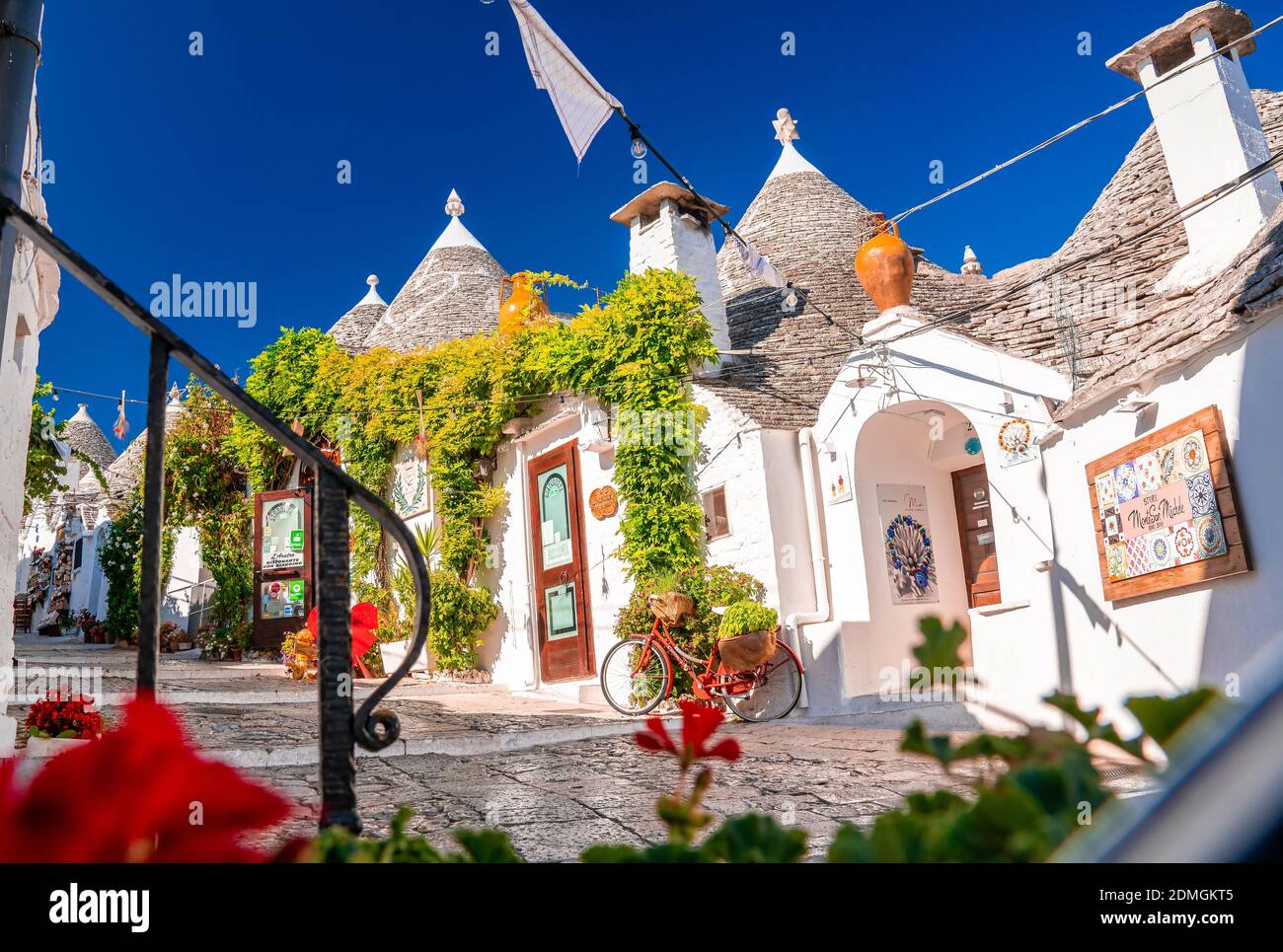 The traditional trulli white houses under the blue sky in Alberobello ...