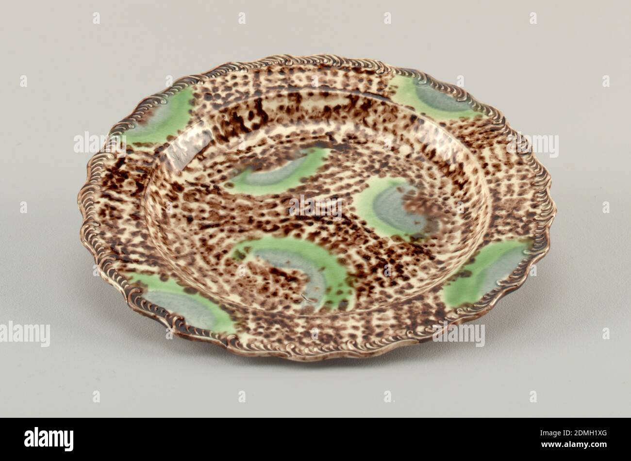 Plate, Thomas Wieldon Factory, English, Lead-glazed earthenware, Plate with wavy border, brown speckled pattern with green and light bluish-grey biomorphic shapes., England, ca. 1760, ceramics, Decorative Arts, Plate Stock Photo