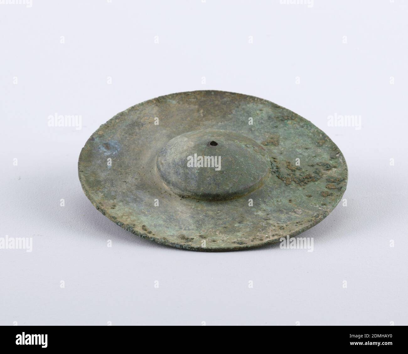 Cymbals, Bronze, Circular form with raised dome, small hole in center. Green patina., Luristan (western Iran), ca. 1000 BCE, metalwork, Decorative Arts, Cymbals Stock Photo