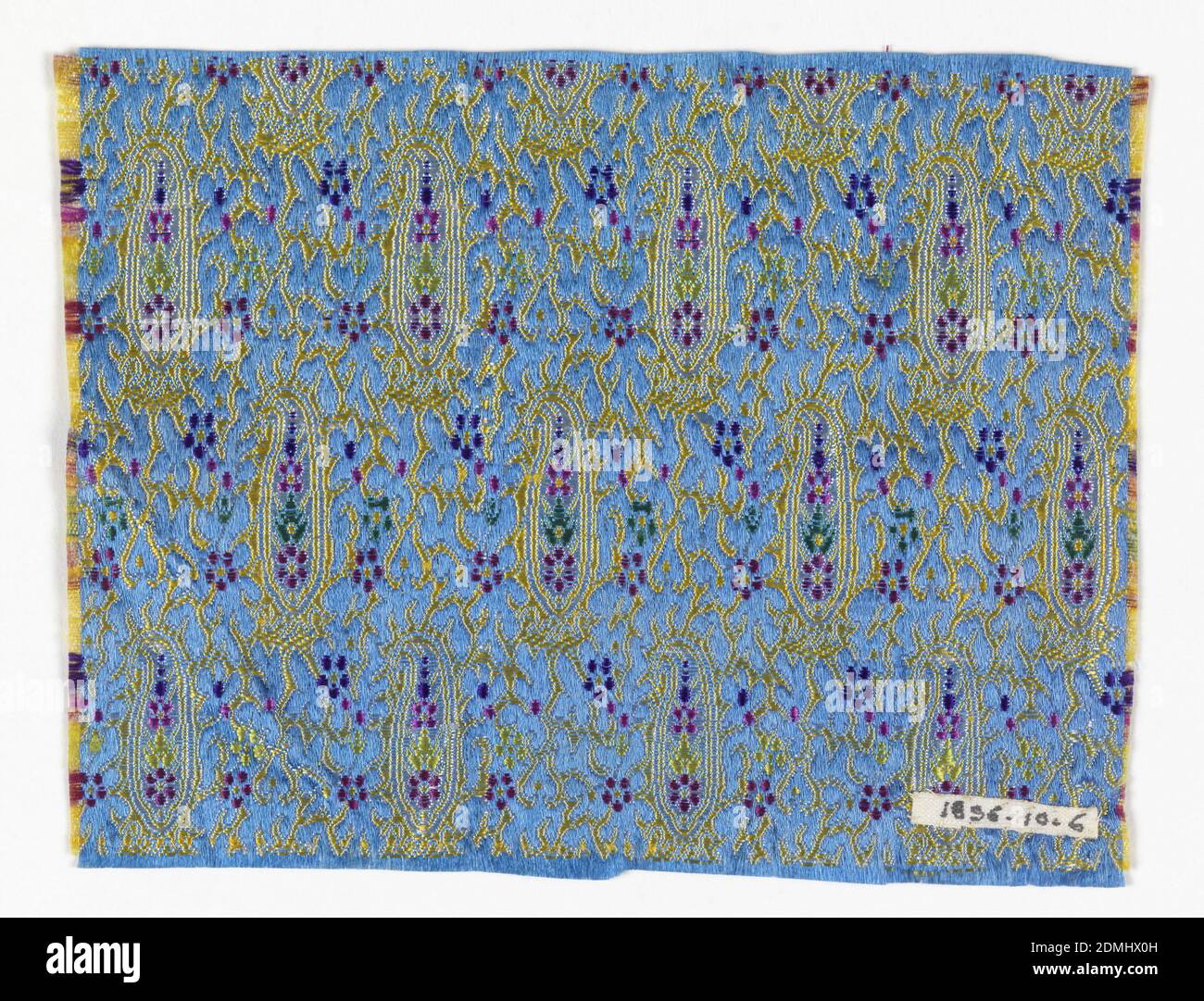 Fragment, Medium: silk Technique: compound satin weave Label: silk compound satin, Fragment of woven silk with a yellow paisley pattern on a blue ground. Flowers and details in white, pink, green, red, and purple., Japan, late 19th century, woven textiles, Fragment Stock Photo