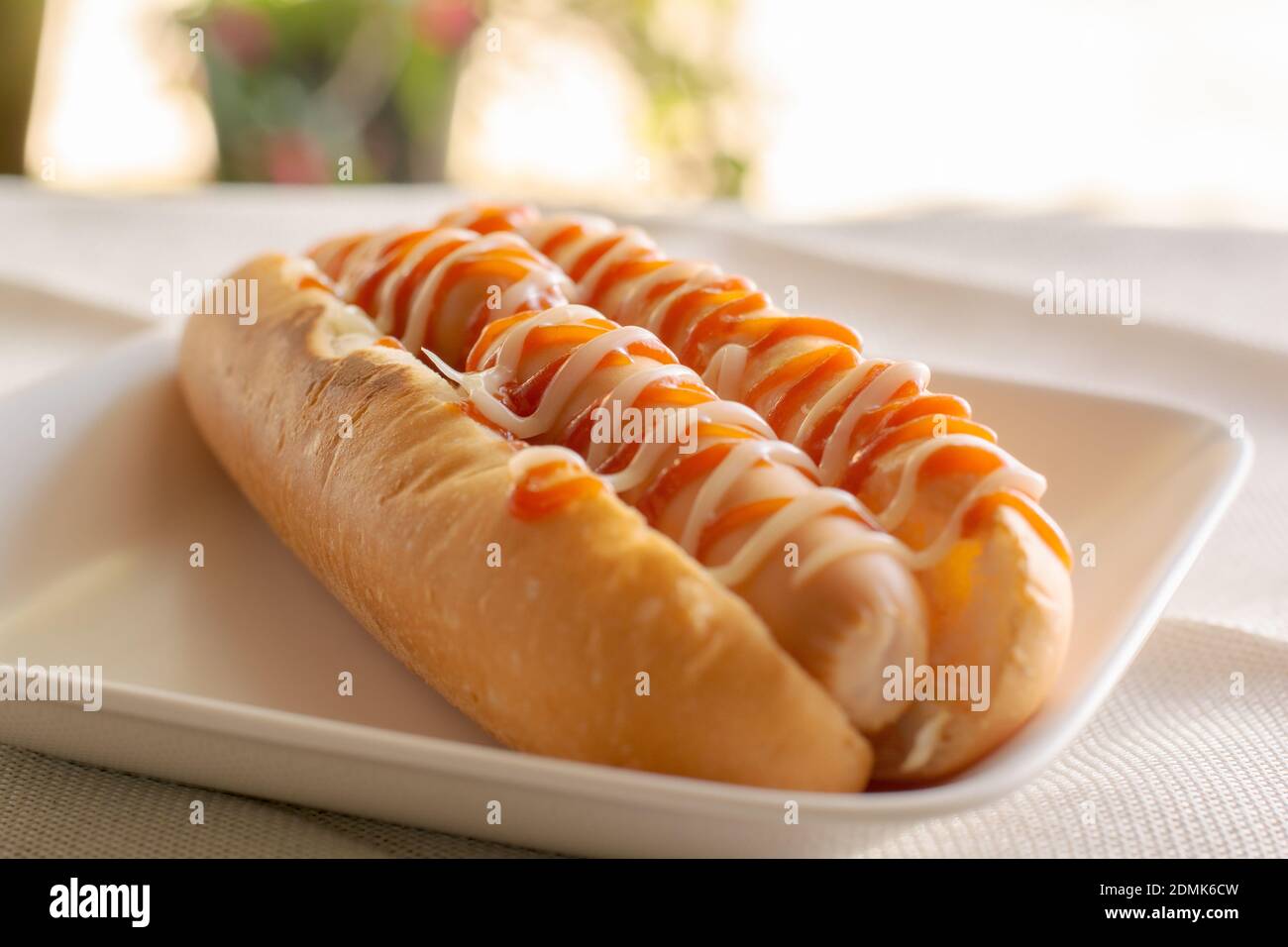 Top View Hot Dog With Bun And Ketchup, Mayonnaise On White Plate