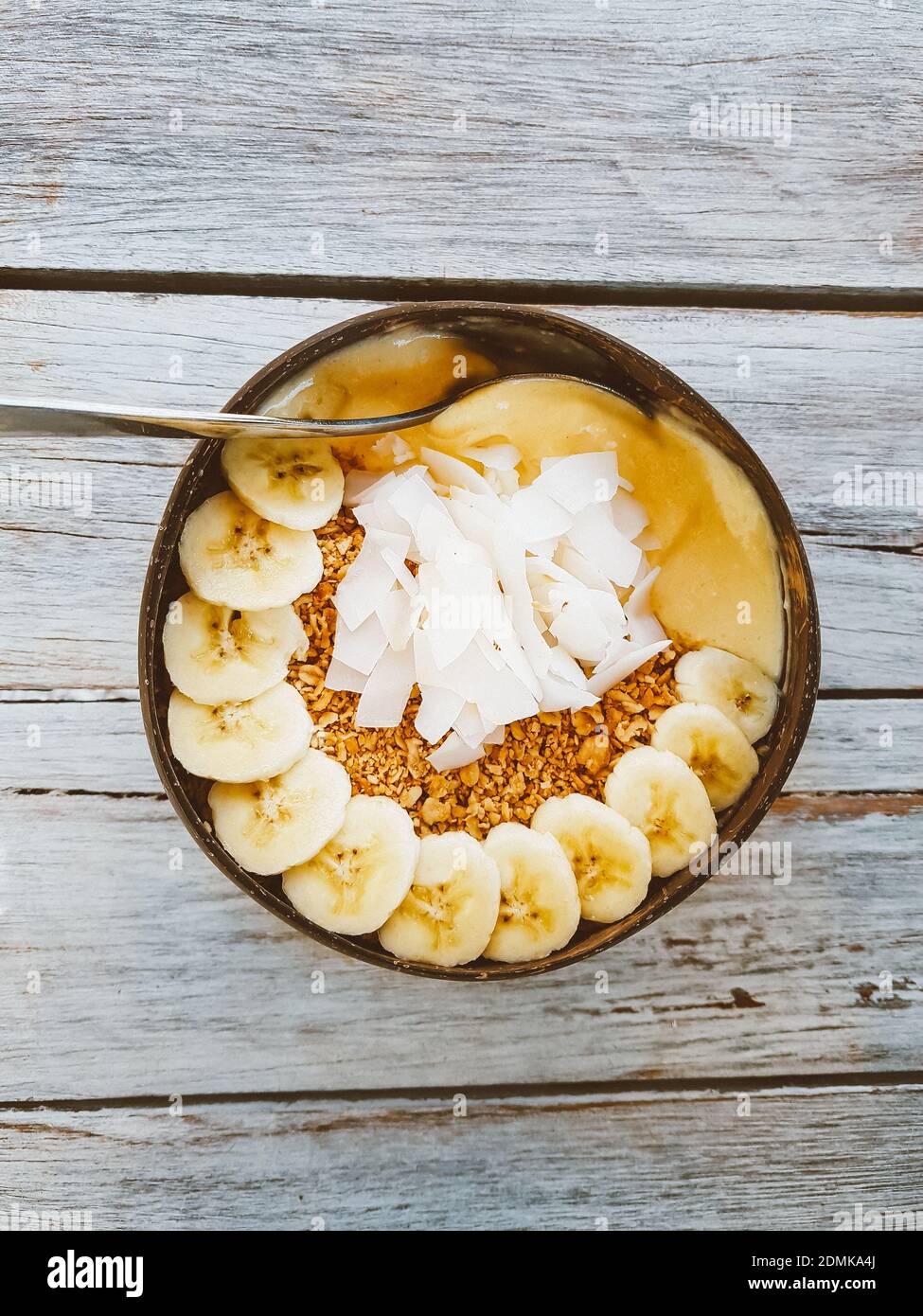 Healthy Banana Coconut Peanut Butter Smoothie Bowl With Granola And Coconut  On Top Stock Photo - Alamy