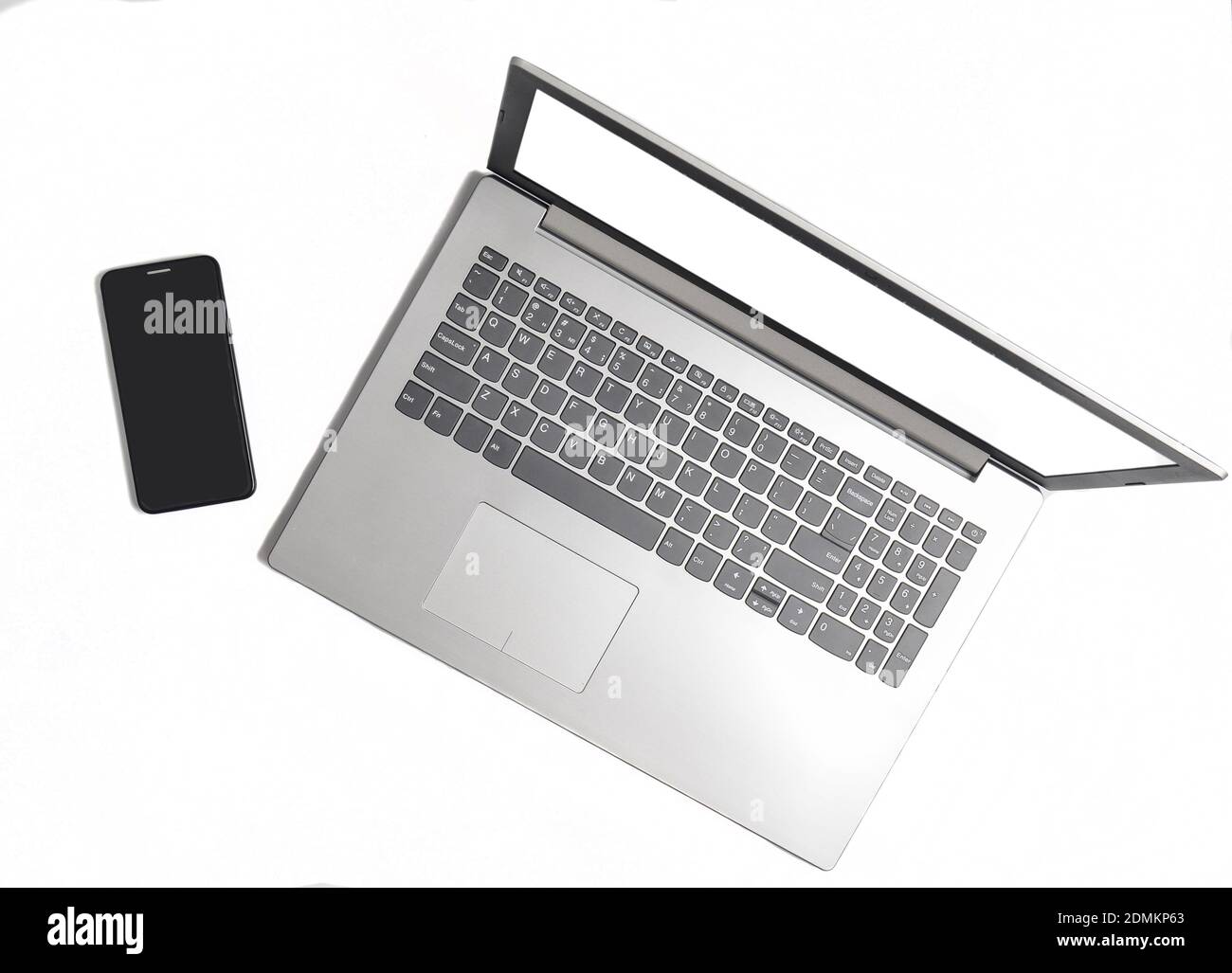 Laptop and frameless phone on a white background. Modern technological gadgets, white screens for copy space Stock Photo