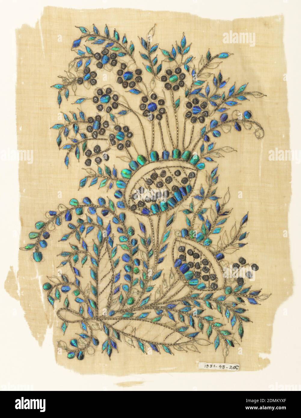 Fragment, Medium: cotton ground, beetle elytra, gold foil strips, gilt sequins, gold metal-wrapped silk thread Technique: plain weave embroidered with cut beetle wings and sequins, Off-white cotton sheer ground with embroidered design of a stylized floral spray with two large blossoms and numerous small ones curving to the left. The vines are executed in gold foil strips, the small flowers in gilt sequins, and the leaves in beetle elytra., India, mid- 19th century, embroidery & stitching, Fragment Stock Photo
