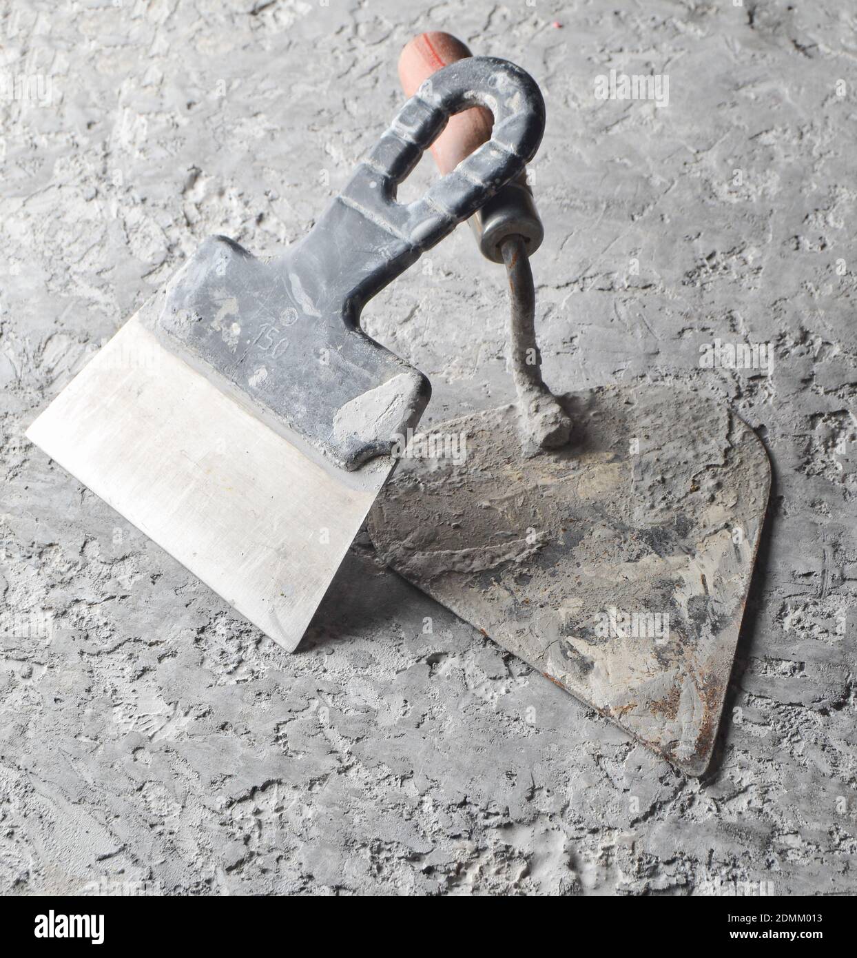 Building tools on a gray concrete background. Spatula, trowel Stock Photo