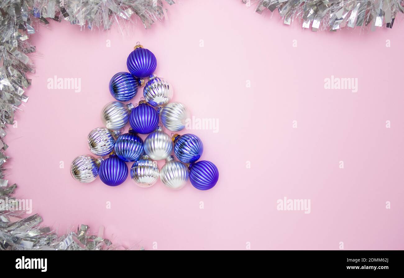 Christmas balls for decorating blue and silver on a pink background in ...