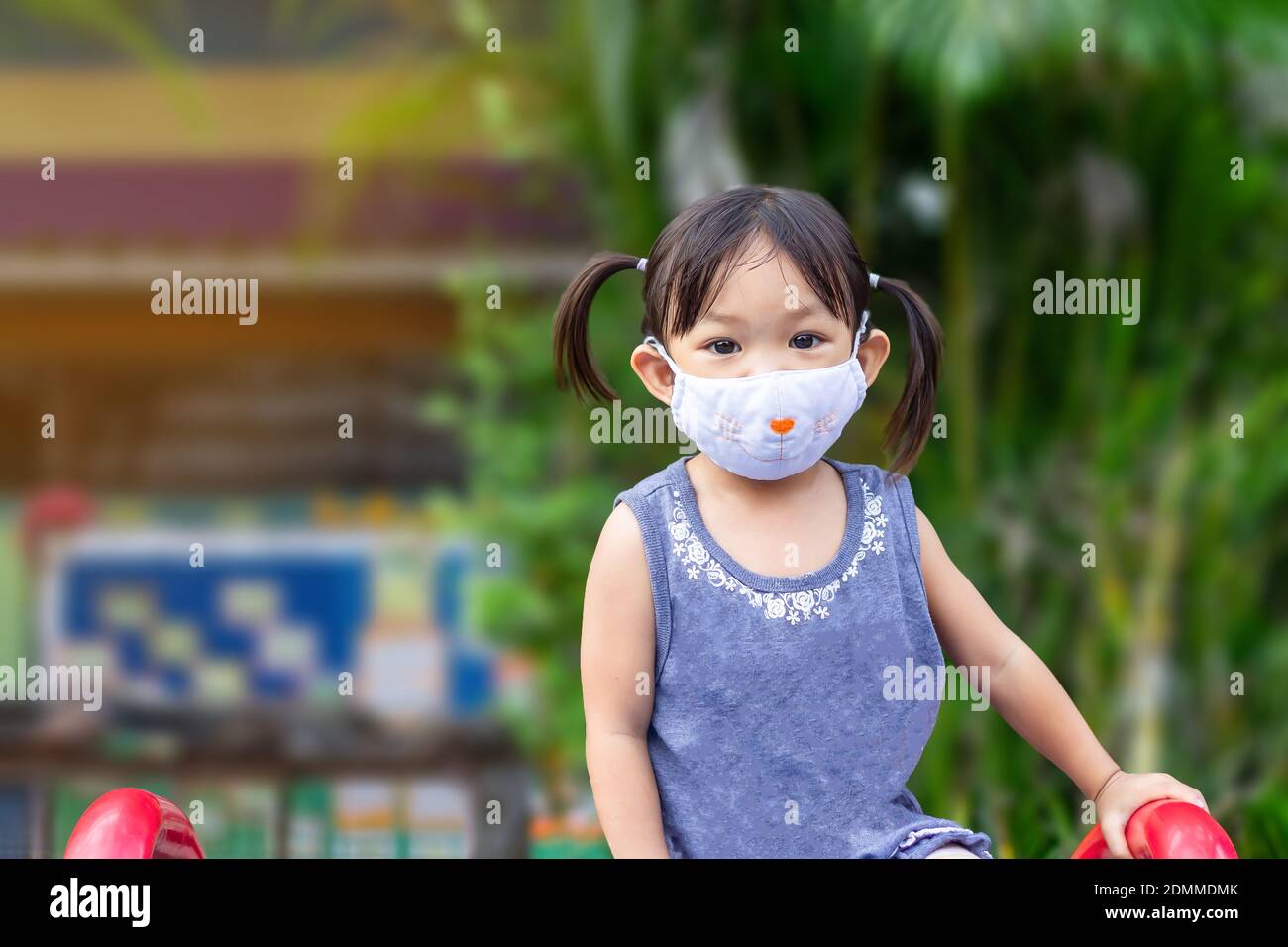Portrait Of Cute Girl Wearing Mask Standing Outdoors Stock Photo Alamy