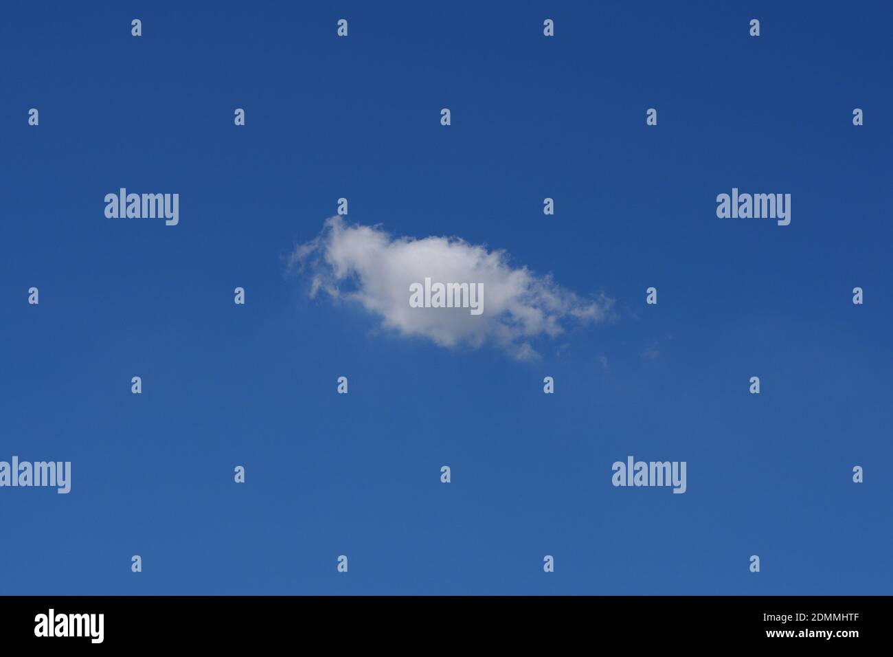 Beautiful cloudscape of nature single white cloud only one on blue sky background in daytime Stock Photo