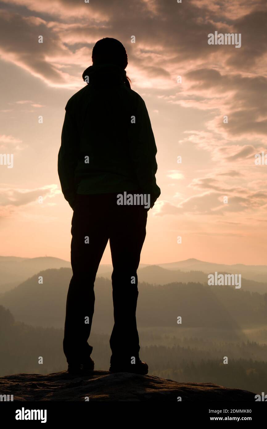 Hiker Stand On The Sharp Corner Of Sandstone Rock In Rock Empires Park And Watching Over The Misty. Stock Photo