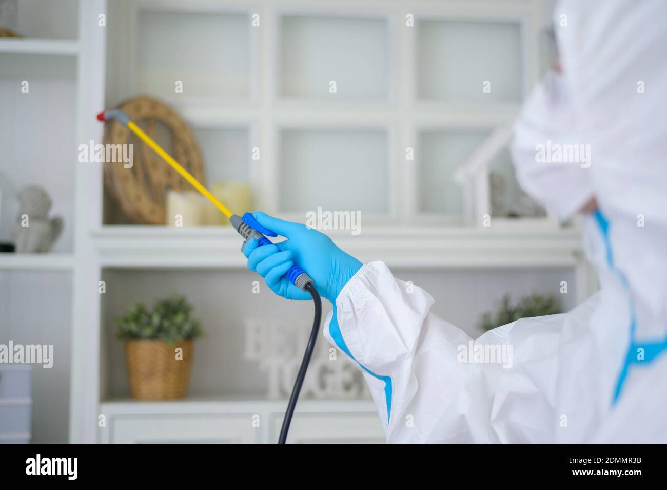 Close-up Of Man Disinfecting Home Interior Stock Photo