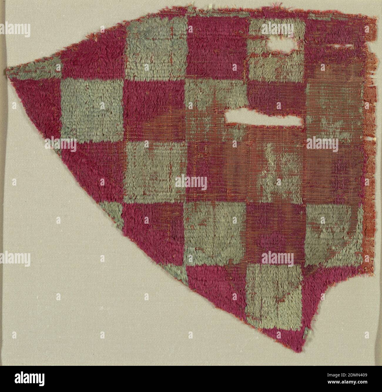 Fragment, Medium: silk Technique: cut supplementary warp pile (velvet) in a plain weave foundation, Fragment in a checkerboard pattern of red and faded green squares., Spain, 10th–11th century, woven textiles, Fragment Stock Photo