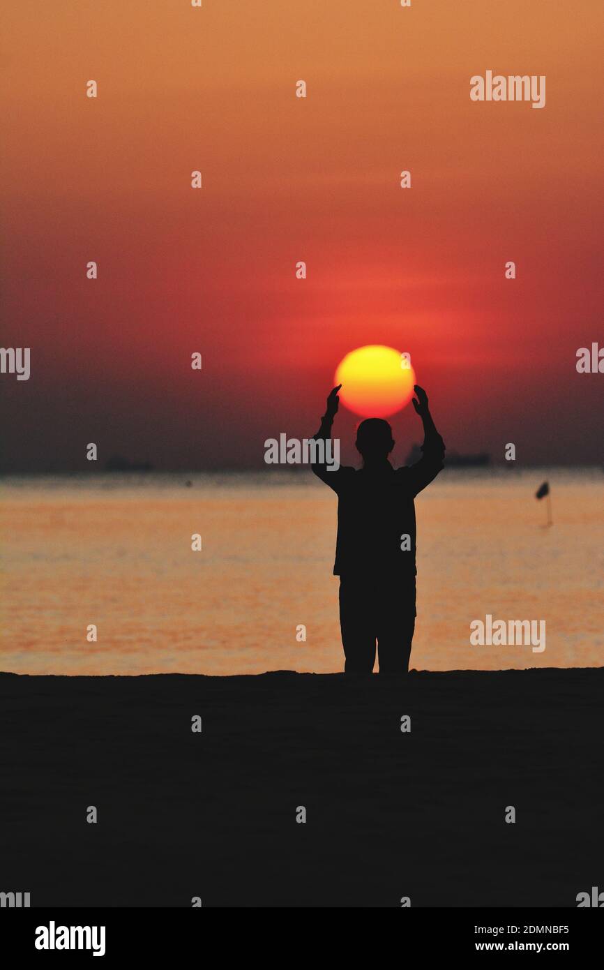 Silhouette Man Standing On Beach During Sunset Stock Photo - Alamy