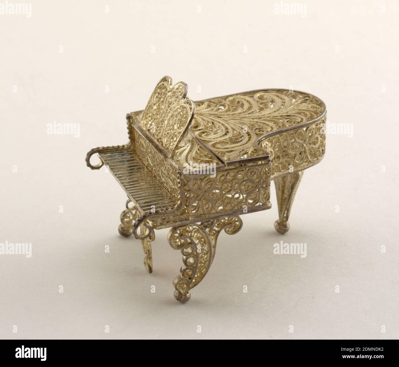 piano, Silver filigree, Grand piano. Lid can be raised. Scrolled front legs, baluster rear leg. All-over decoration on case and rack of scrolled and rosetted filigree., Italy, late 19th century, miniatures, Decorative Arts, Miniature of a piano, Miniature of a piano Stock Photo