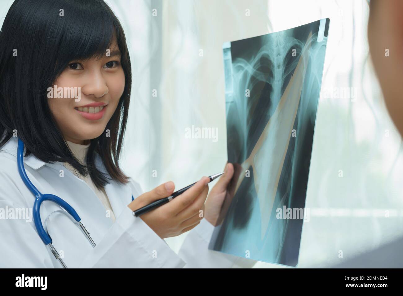 Smiling Doctor Pointing At Medical Xray At Hospital Stock Photo Alamy