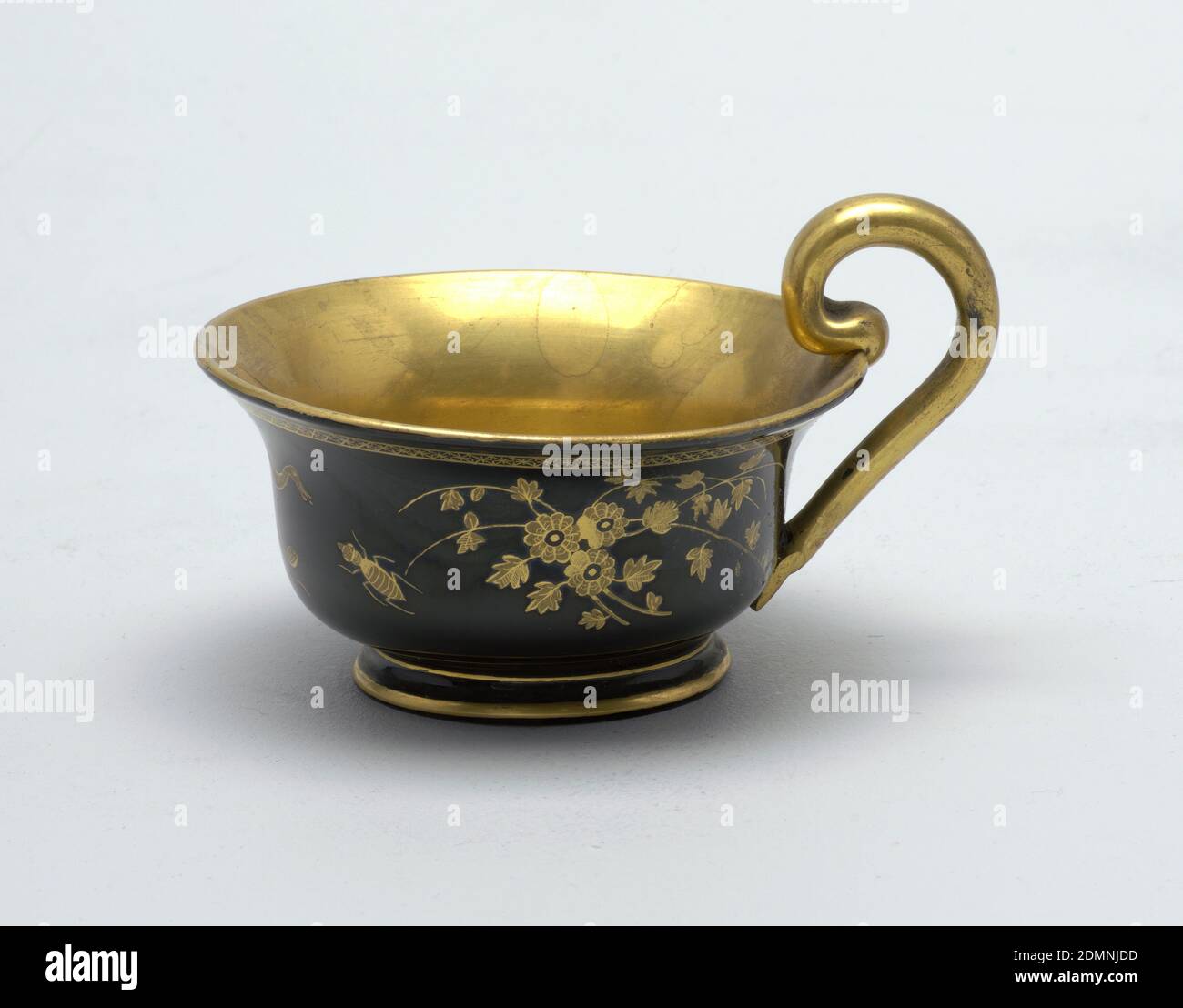 Cup and saucer, Glass, Gold and black decoration,gold cup interior and handle; exterior black with gold decoration (floral and animal). Saucer black with gold geometric border and gold floral and animal decoration., Austria or Bohemia, 19th century, glasswares, Decorative Arts, Cup and saucer Stock Photo