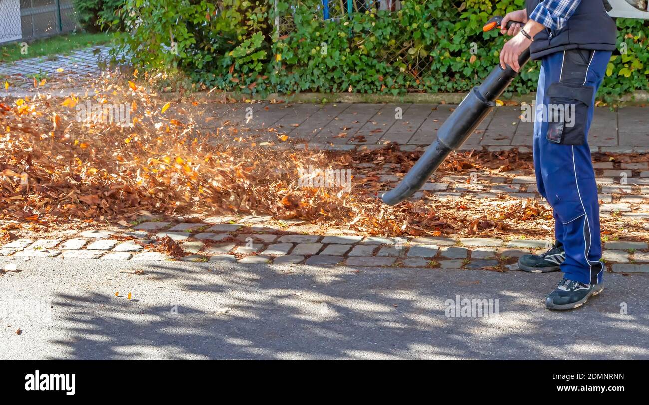 Low Section Of Man Working On Road Stock Photo