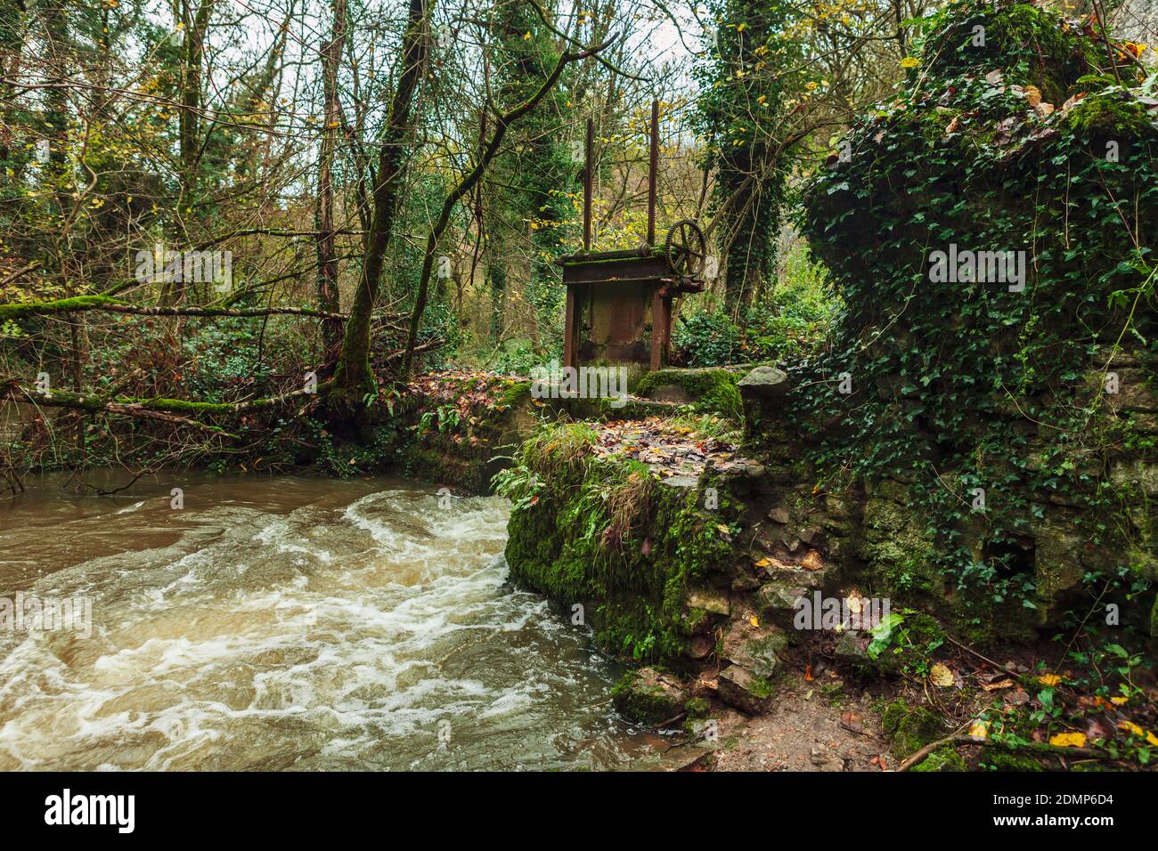 Old Sluice gate on the river, at the abandoned Fussells iron works in Mells, Somerset, Uk Stock Photo