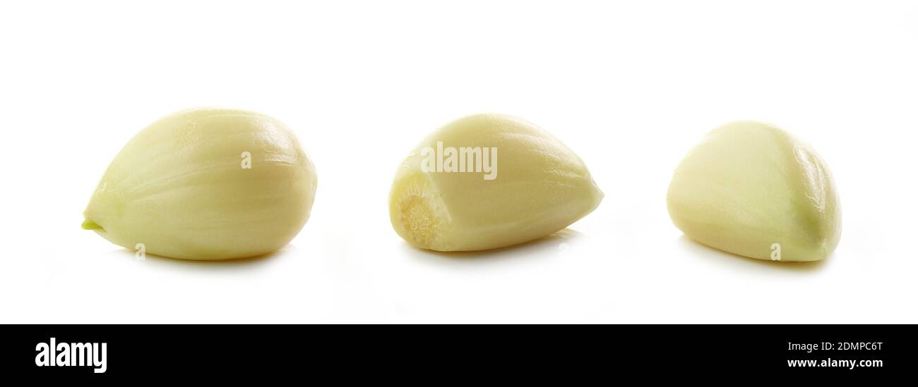 three garlic cloves macro isolated on white background Stock Photo