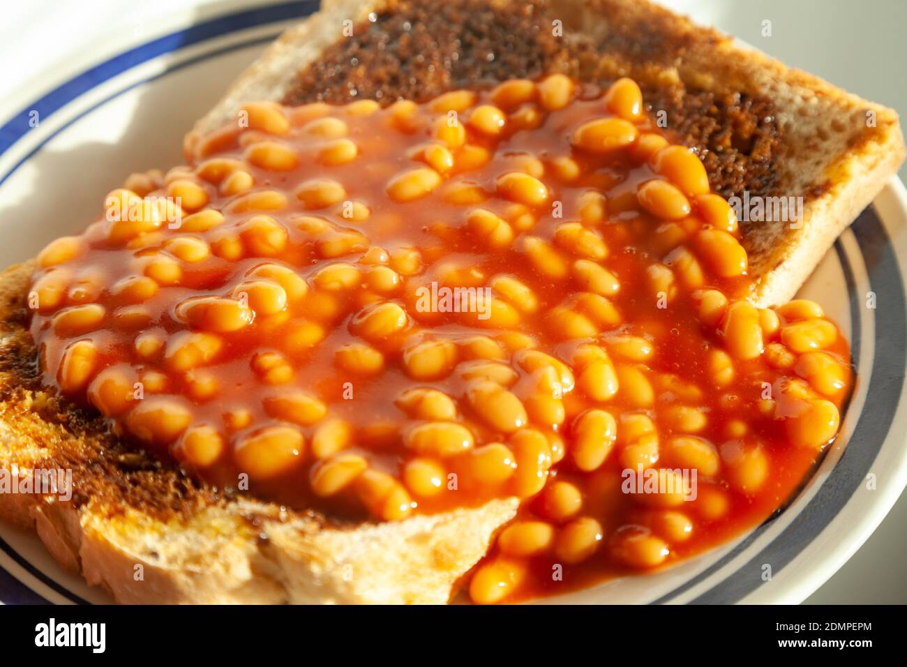 A close up of baked beans on toast. Stock Photo
