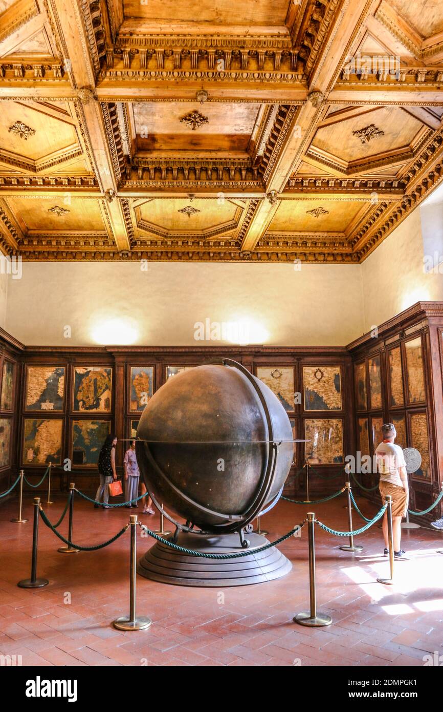 Great portrait shot of the Hall of Geographical Maps with the finely crafted and carved walnut cabinets and ceiling panels and the famous globe, known... Stock Photo