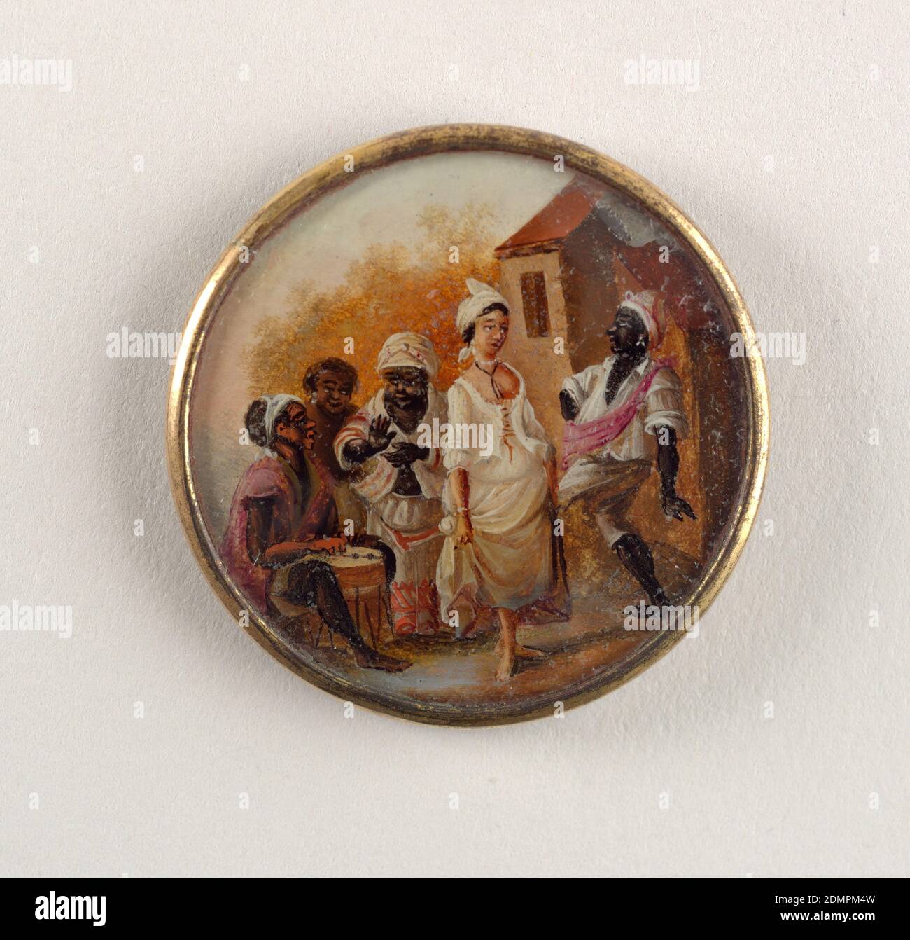 Button, Gouache paint on tin verre fixé, ivory (backing), glass, gilt metal, Button depicting scene of five figures outside near a large house. From left: a seated man, wearing a pink shirt, playing a drum, a woman with only head visible standing behind another woman, wear white with pink stripes, who claps [to the music]. In the foreground, a lighter skinned woman wearing an open corset and skirt dances with a man who wears white clothing and a pink sash., late 18th century, costume & accessories, Decorative Arts, Button Stock Photo
