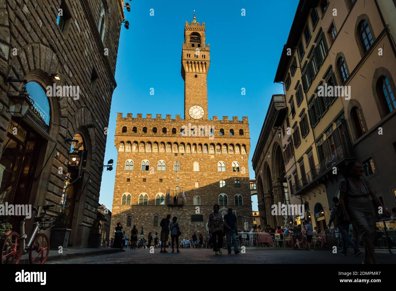 Lovely full view of the famous Palazzo Vecchio museum with the Arnolfo’s tower in the square Piazza della Signoria seen from the busy street Via... Stock Photo