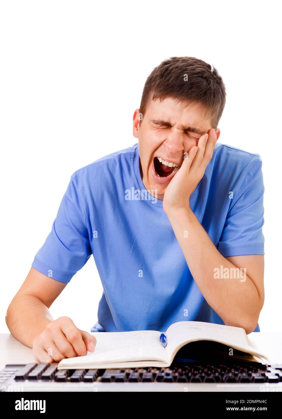 Tired Student Yawning on the School Desk Isolated on the White Background Stock Photo