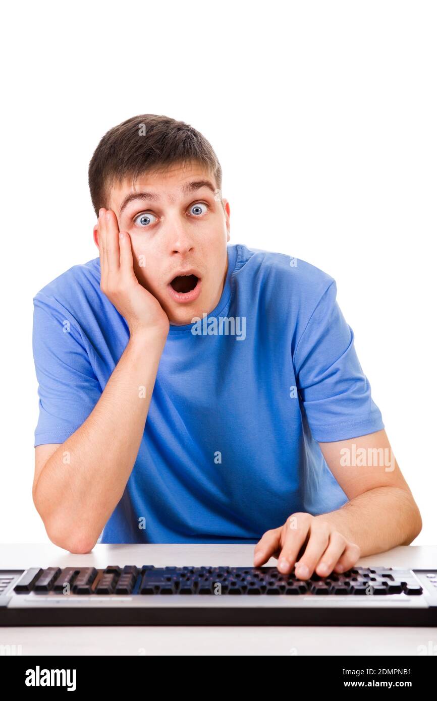 Surprised Young Man with a Computer Keyboard on the White Background Stock Photo