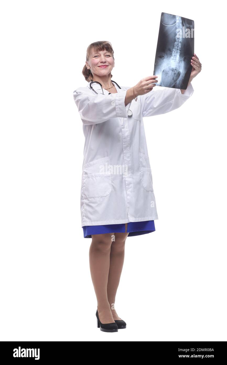 Attractive female nurse or doctor wearing lab coat and stethoscope reviewing an X-ray Stock Photo