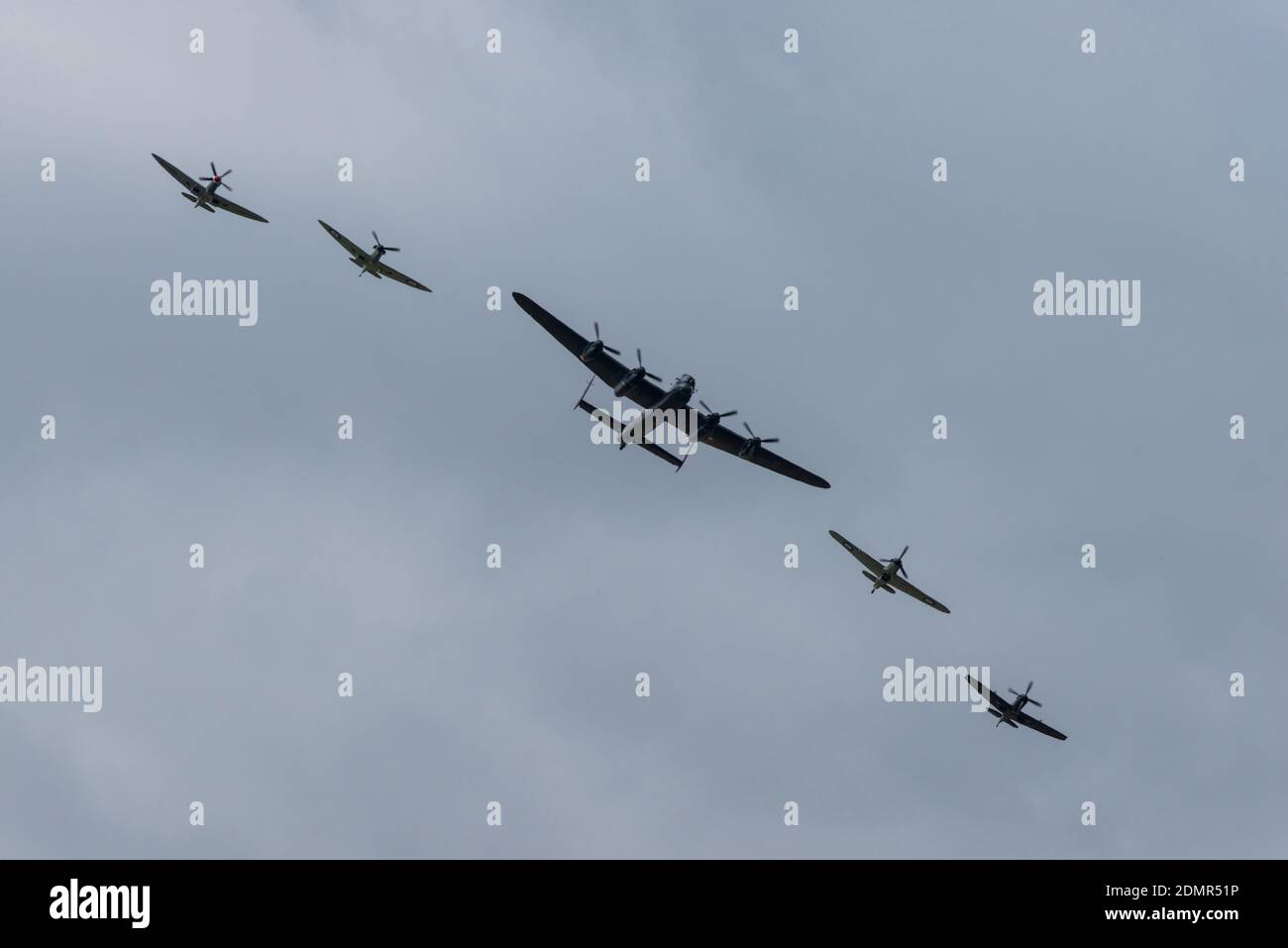 A flight formation of an Avro Lancaster bomber with Supermarine Spitfires and a Hawker Hurricane fighters at the RIAT air-show in England Stock Photo
