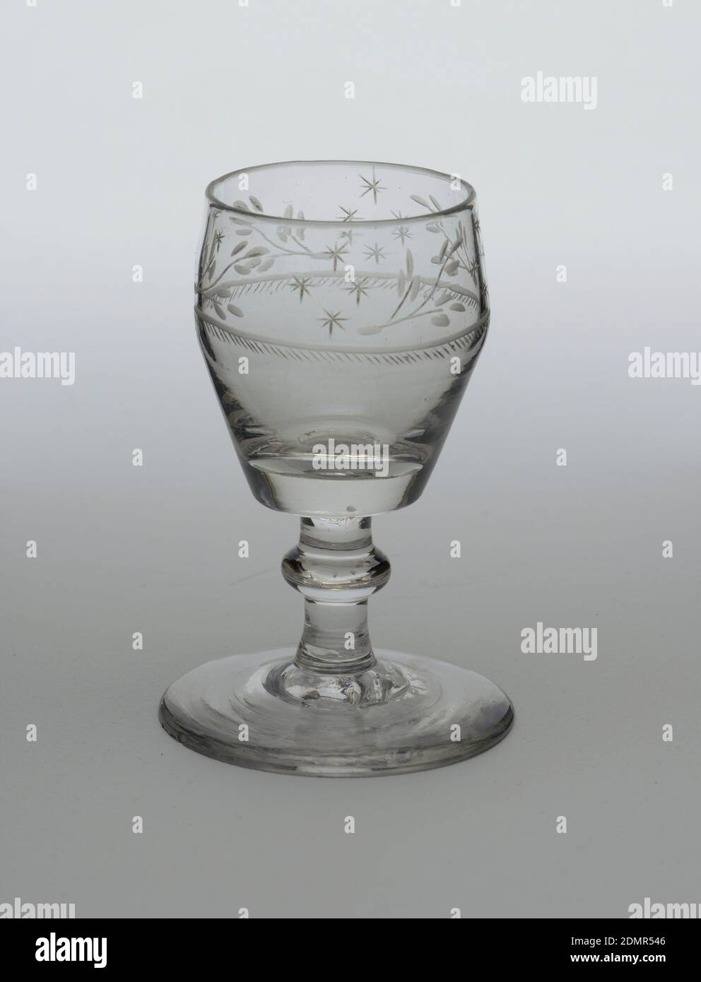 goblet, glass, Small, inverted pear-shaped bowl with flat bottom, short stem with flattened globular knop and broad, circular foot. Wheel engraved on upper part of bowl with alternating sprays and stars in groups of 4. Below, one ring and row of small hatch marks encircle bowl., Ireland, ca. 1810–25, glasswares, Decorative Arts, goblet Stock Photo