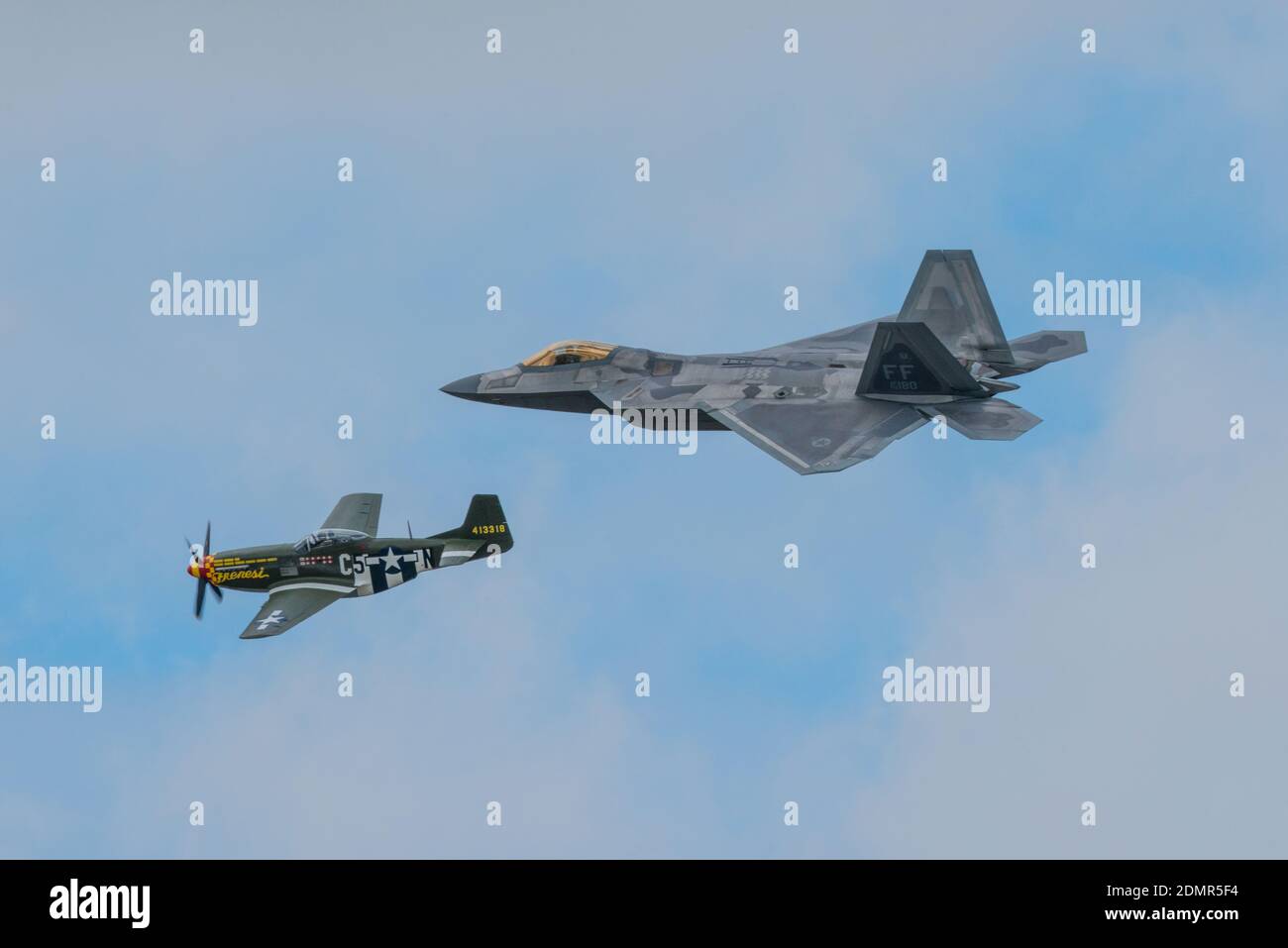 A P51 Mustang and a F22 fighters flying in formation at the RIAT air