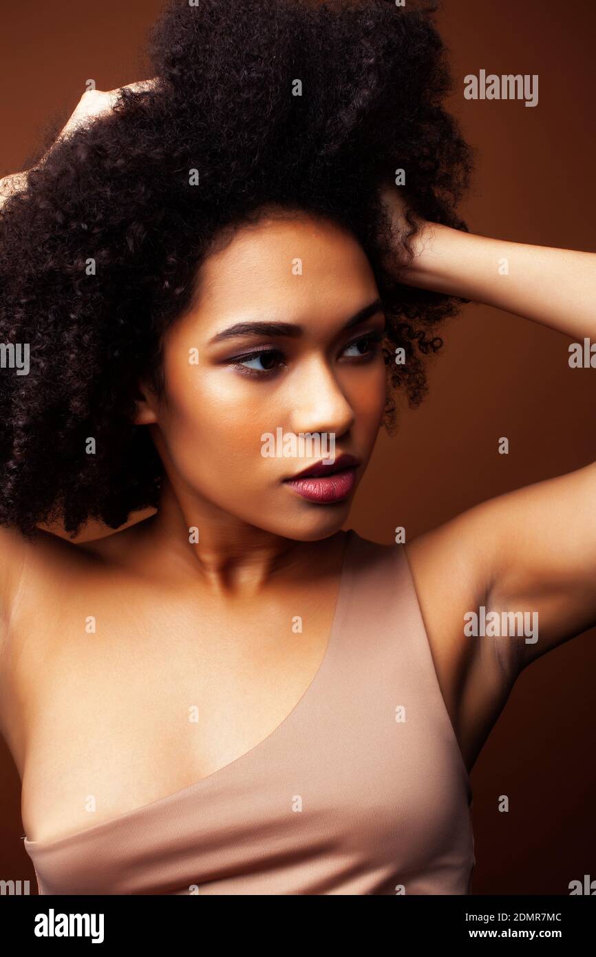 pretty young african american woman with curly hair posing cheerful ...