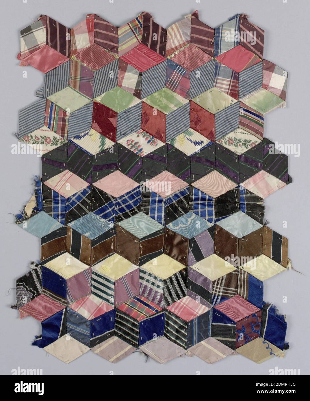 Tumbling Blocks, Medium: silk Technique: pieced and sewn patchwork of woven fabrics, Fragment of a quilt top in 'Tumbling Blocks' pattern, made from small diamond shapes stitched together to create the illusion of cubes. The woven pieces are in silk stripes, plaids and a few small floral patterns., New York, New York, USA, 1870–79, embroidery & stitching, Patchwork fragment, Patchwork fragment Stock Photo