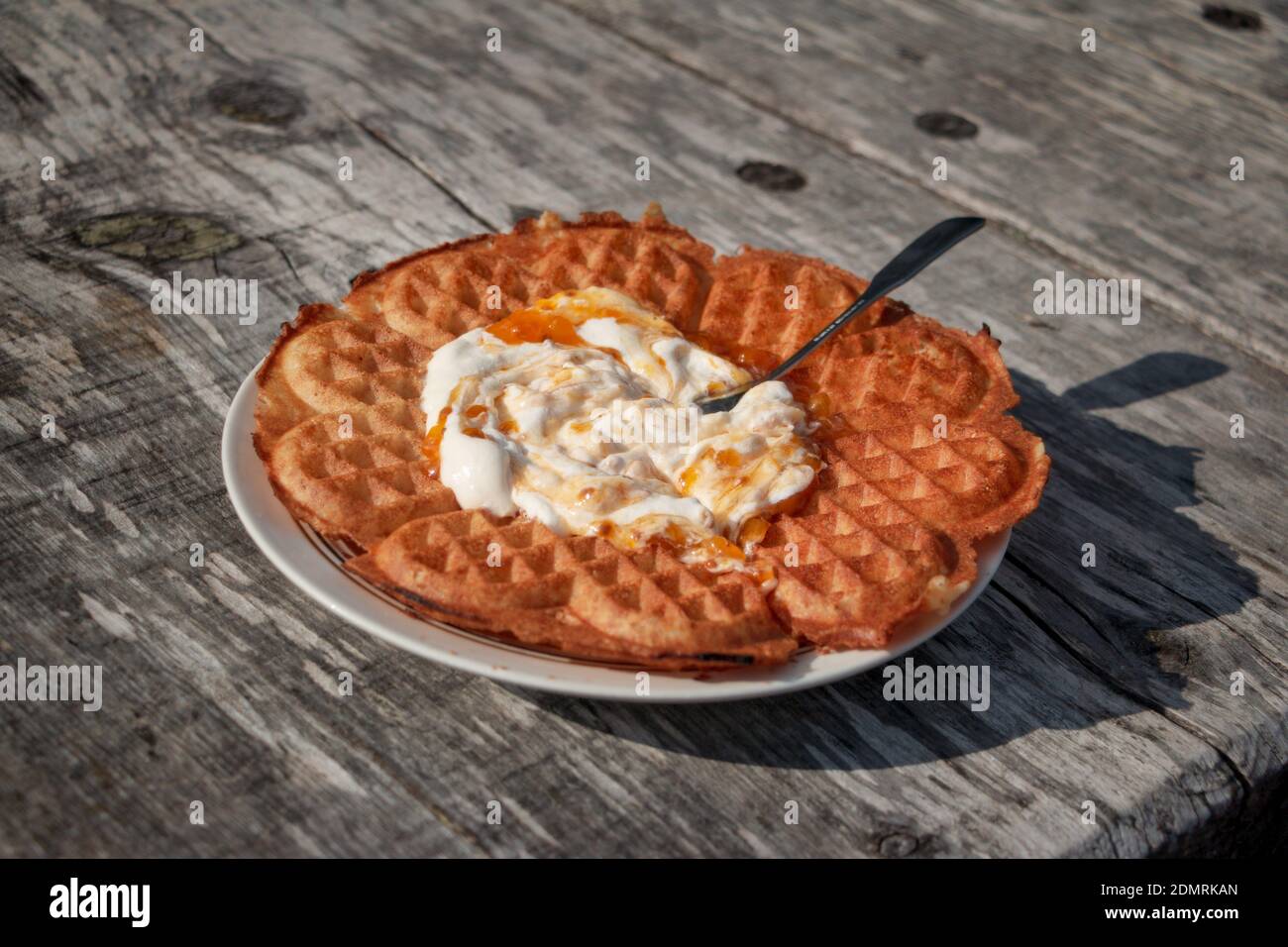 Swedish Waffle With Cloudberry Jam And Whipped Cream Outdoors In The