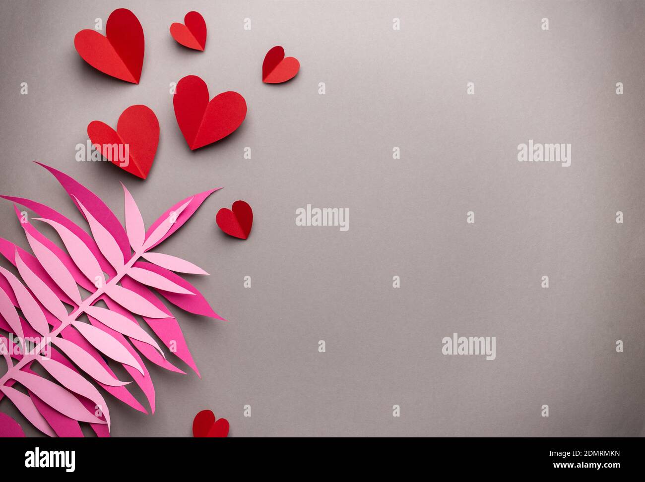 Red hearts cut from paper on pink background, paper craft origami style ...
