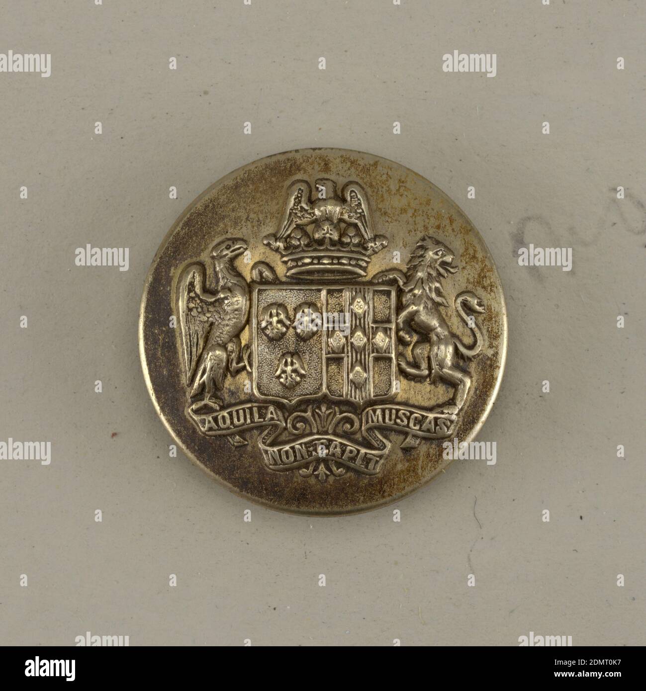 Button, Nickel, brass, Circular, slightly convex button with ornament showing a shield with heraldic devices, eagle and lion supporters, a crown above and below, ribbon with 'Aquila non capit Muscas'. Brass back and shank. On reverse: 'C T paris'. 'Perfectionne' on belt with buckle., On card E, France, 1801–50, costume & accessories, Decorative Arts, Button Stock Photo