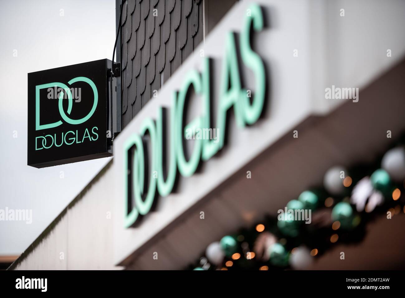 Dinslaken, Germany. 17th Dec, 2020. The lettering with the current logo of the Douglas company hangs on an exterior wall. The store is now only open as a pick-up station. Douglas has reversed the decision to keep some stores open despite the lockdown. For many people, the decision to keep some stores open with drugstore products was not understandable, the company announced on Thursday (17.12.2020). Credit: Fabian Strauch/dpa/Alamy Live News Stock Photo