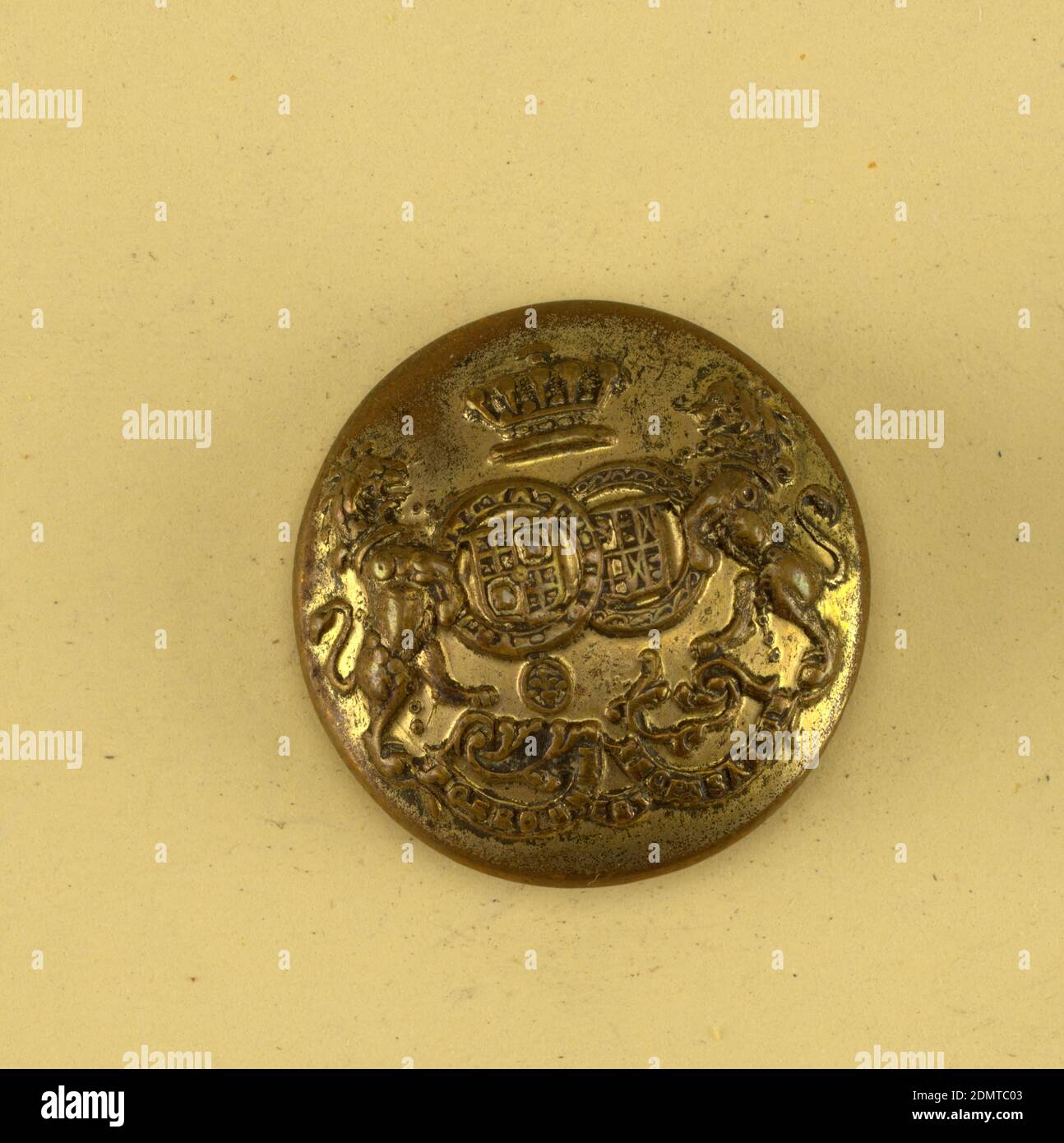 Button, Brass, Convex button showing coat of arms; two sheilds with heraldic  devices surrounded by chains, lions supporters crown above and below,  ribbon with 'Porro unum est necessitarium'. Brass back and shank.