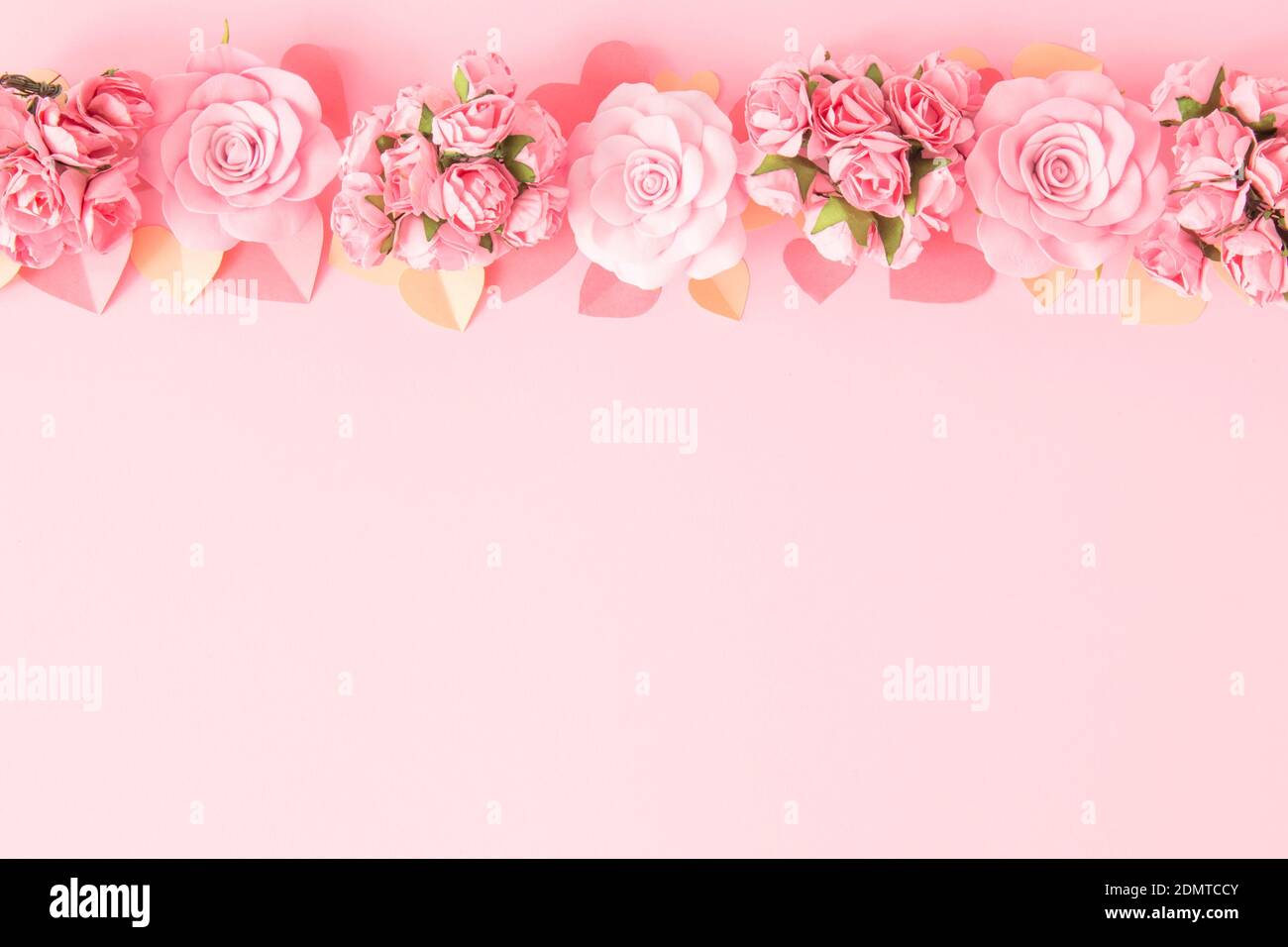 Valentines day background. Border frame of pink flowers and hearts on pink background. Happy Valentine's Day banners. Pastel tone. Copy space. Stock Photo