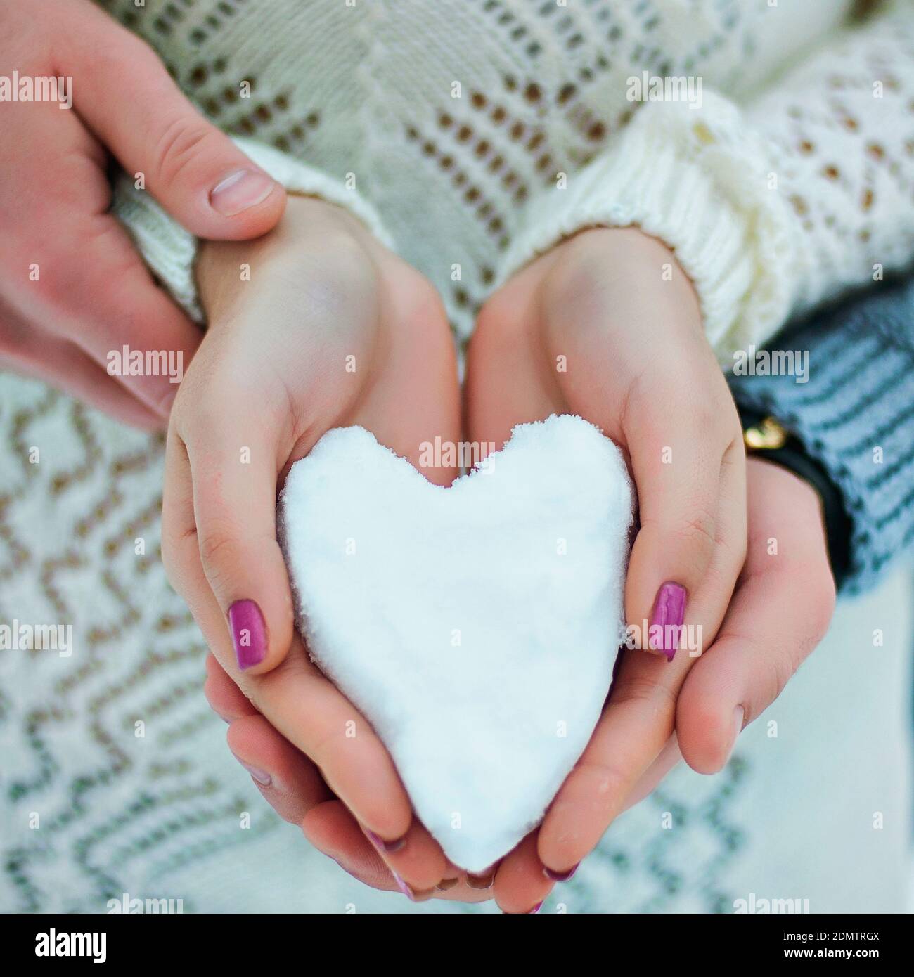 Heart from white snow for valentine's day. Like symbol of love. Top view. Flat lay. .Creative ideas of gifts to Valentine's Day. 14 of February. Stock Photo