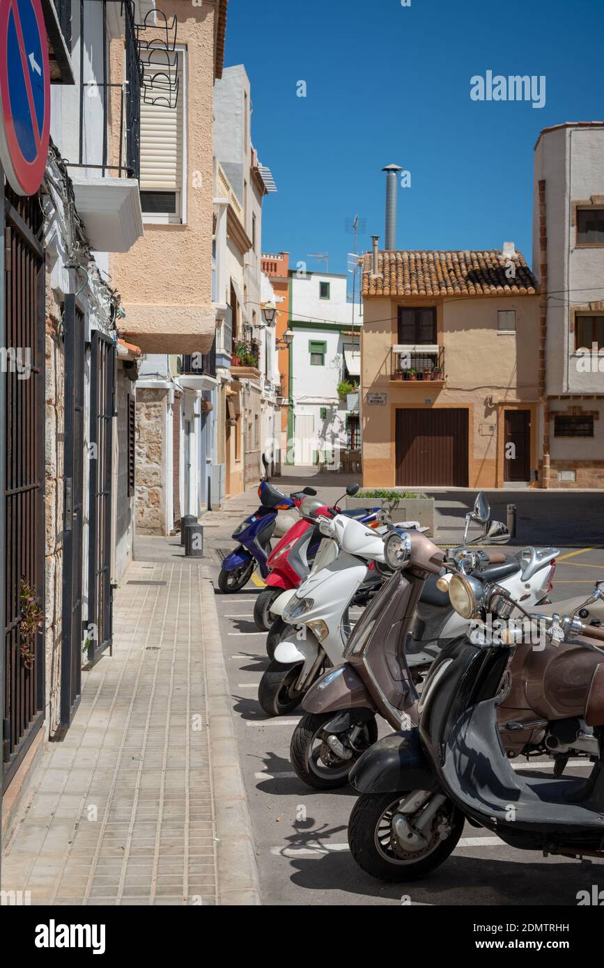 Denia, Costa Blanca, Alicante, Spain. Scooters and motorcycles parked in the street outside