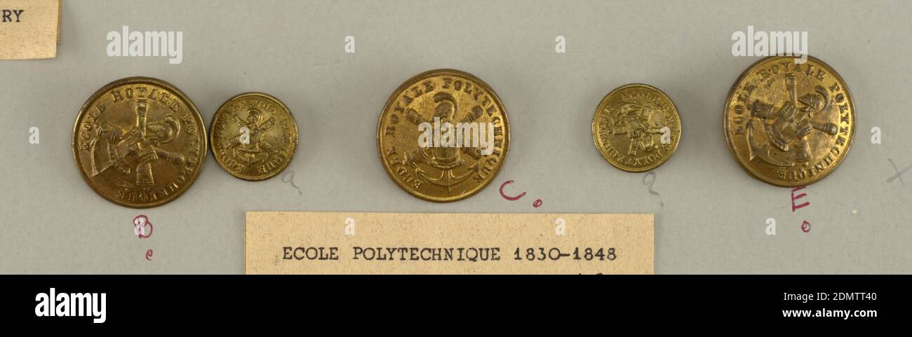 Button, Brass, Insignia composed of suite of half-armor on crossed guns and an anchor surrounded by the words, 'Ecole Royale Polytechnique'. In use during the years 1830-1848., Components -b,-c,-e and -f,-g, which are smaller, France, 1830–48, costume & accessories, Decorative Arts, Button Stock Photo